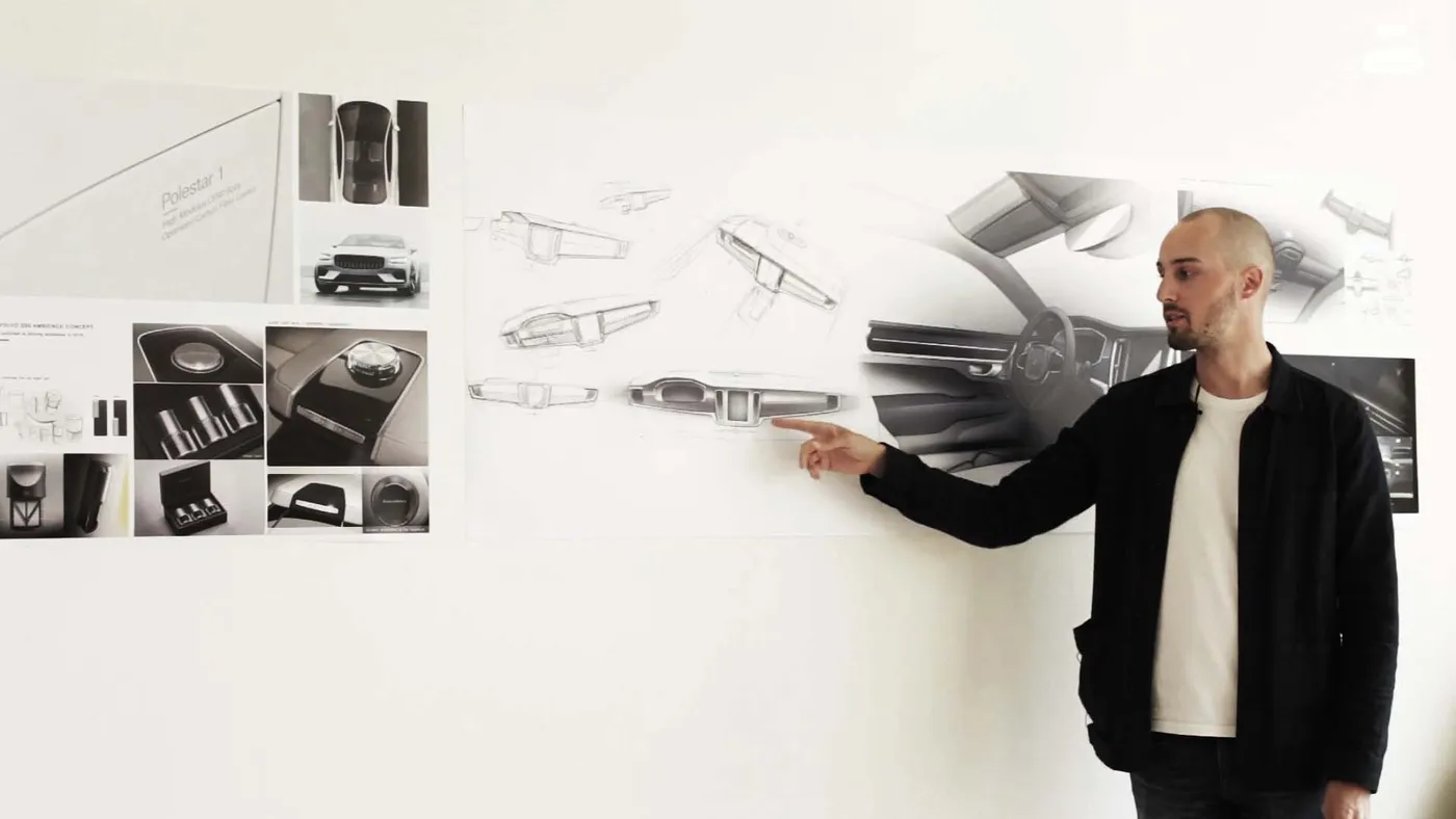 Tutor in front of poster wall